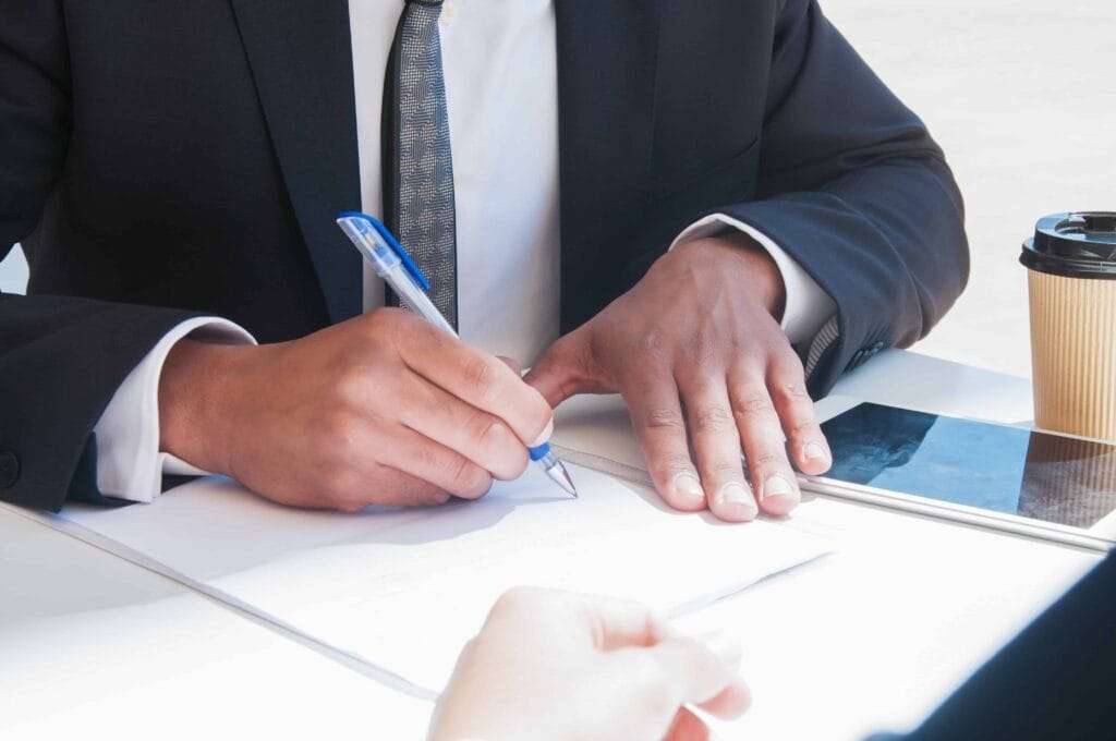 Freezone Company Formation – Other Emirates 6 closeup business man writing paper sheet table 1