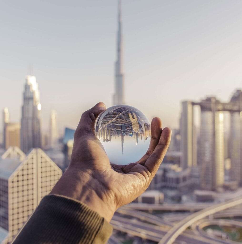 Freezone Company Formation in Dubai 15 closeup shot male hand holding crystal ball with reflection city 1