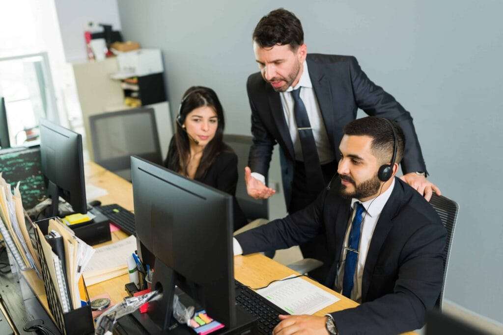 Representative Office of a Foreign Company in the UAE 4 male supervisor training latin executive call center manager explaining work stuff employees offering tech support customer service 1