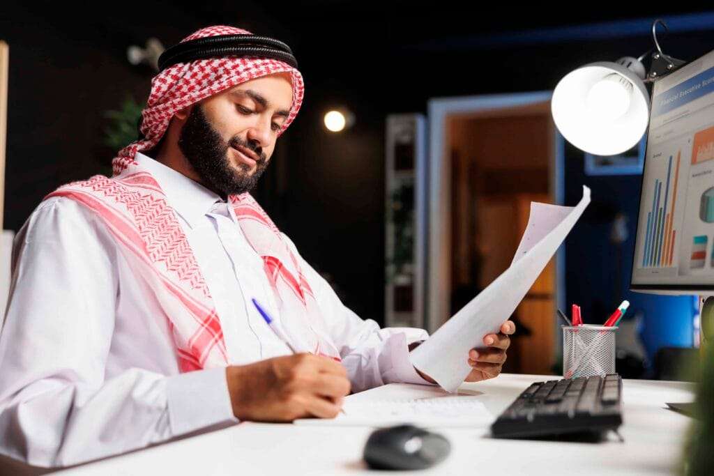 VAT Registration and Filing in Dubai 1 man diligently working his desk 1