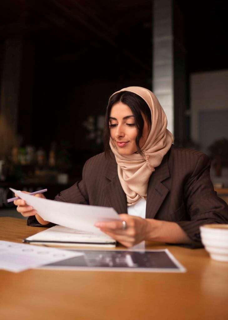 UAE Corporate Tax 4 medium shot woman working with hijab indoors 1