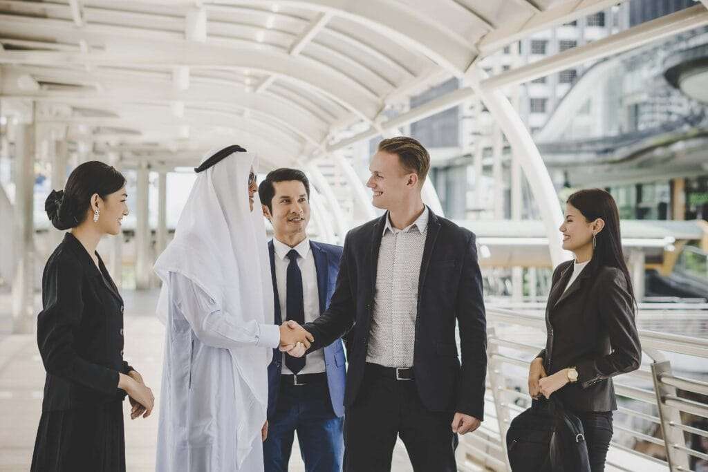Mainland Company Formation in Dubai and Other Emirates 4 portrait business partners greeting one another by handshaking way office 1